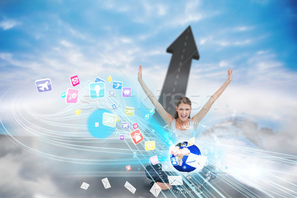 Stock photo: Cheering blonde using laptop with app icons