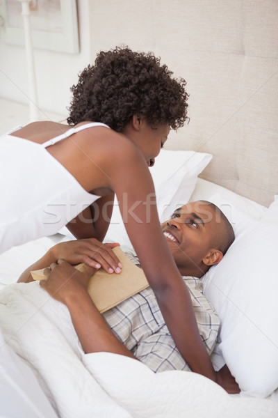 Happy couple in bed together Stock photo © wavebreak_media
