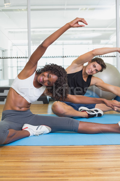 Fit couple warming up on exercise mats Stock photo © wavebreak_media