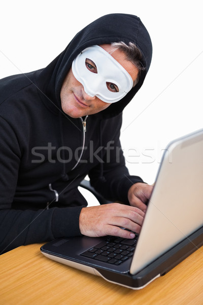 Hacker alb masca folosind laptop uita aparat foto Imagine de stoc © wavebreak_media