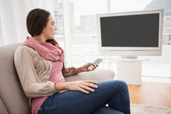Joli brunette regarder tv canapé maison [[stock_photo]] © wavebreak_media