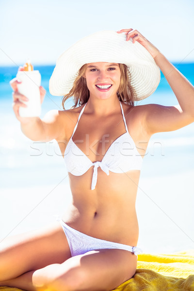 Pretty blonde woman holding sun tan lotion  Stock photo © wavebreak_media