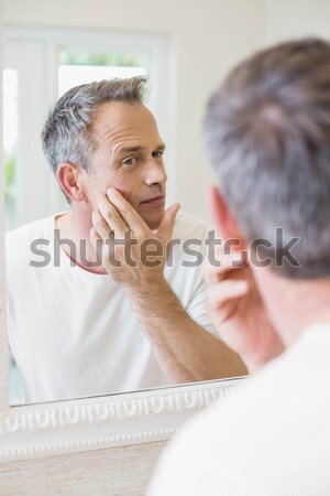 Stock photo: Handsome man washing his face