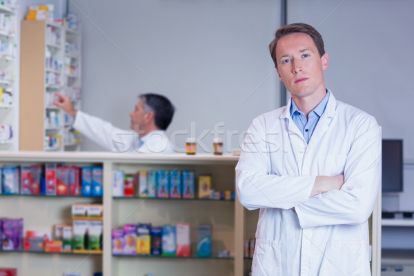 Unsmiling pharmacist standing with arms crossed Stock photo © wavebreak_media