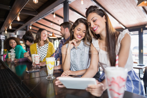 Friends using digital tablet in restaurant Stock photo © wavebreak_media