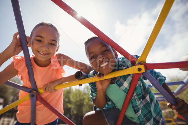 Portrait of happy schoolkids looking through dome climber Stock photo © wavebreak_media