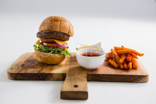 Dips with French fries and burger on cutting board Stock photo © wavebreak_media