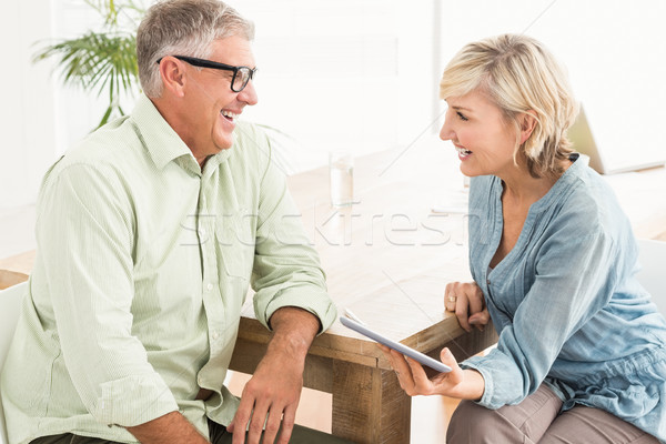 Smiling business team discussing over a tablet Stock photo © wavebreak_media