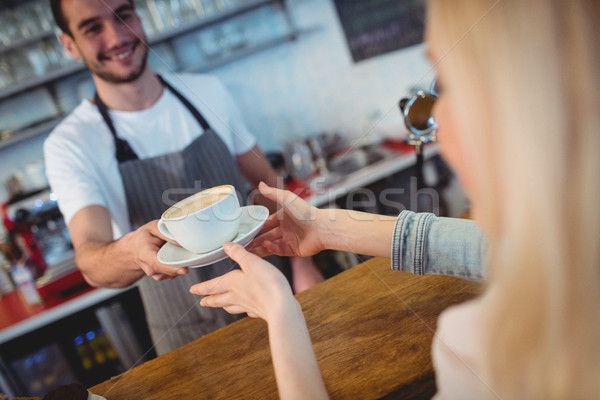 Tilt shot of barista serving coffee to woman at cafe Stock photo © wavebreak_media