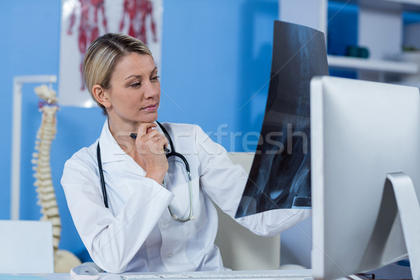 Stock photo: Physiotherapist looking at a x-ray