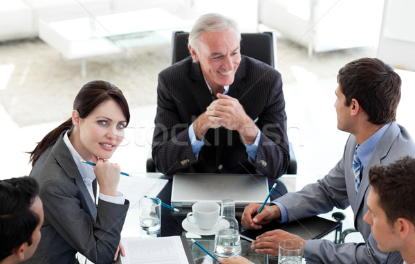 Stock photo: Multi-ethnic business people sitting around a conference table 