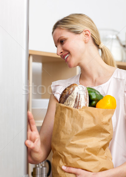 Smiling woman holding a grocery bag  Stock photo © wavebreak_media