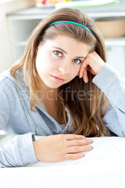 Unhappy woman looking at the camera sitting at a table Stock photo © wavebreak_media