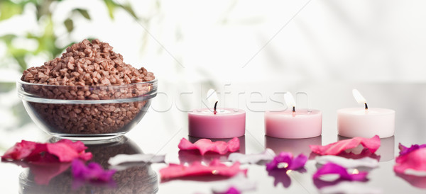 Pink petals with lighted candles and a bowl of brown gravel Stock photo © wavebreak_media