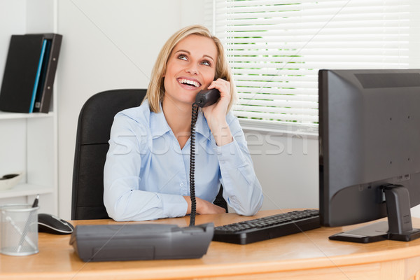 Cheerful businesswoman on phone looking at the ceiling of her office Stock photo © wavebreak_media