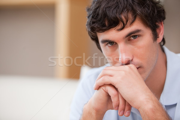 Young man in the living room in thoughts Stock photo © wavebreak_media