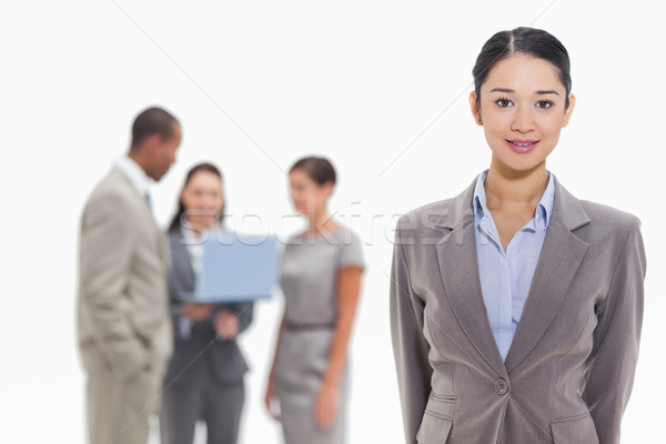 Close-up of a businesswoman with co-workers watching a laptop in the background Stock photo © wavebreak_media