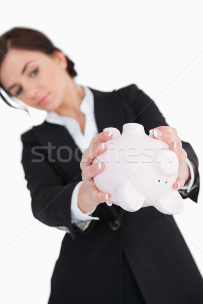 Woman in suit emptying a piggy-bank against white background Stock photo © wavebreak_media
