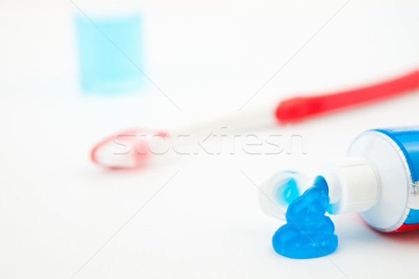 Blue toothpaste outgoing of the tube of toothpaste against white background Stock photo © wavebreak_media