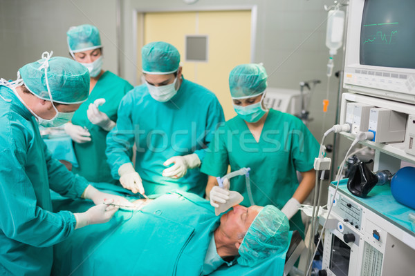 Medical team operating in an operating theatre Stock photo © wavebreak_media