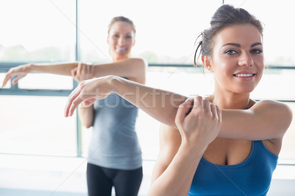 Two women stretching their arms Stock photo © wavebreak_media