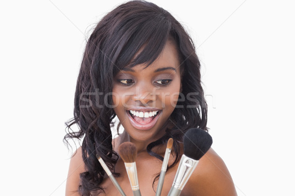 Woman holding makeup brushes and smiling Stock photo © wavebreak_media