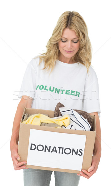 Stock photo: Smiling young woman carrying clothes donation