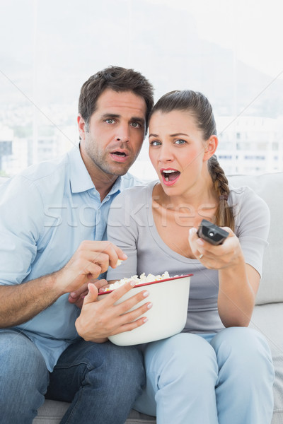 Couple regarder effrayant film canapé bol [[stock_photo]] © wavebreak_media