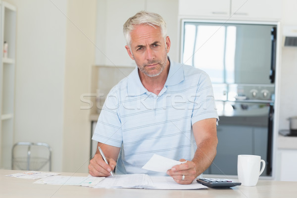Serious man working out his finances Stock photo © wavebreak_media