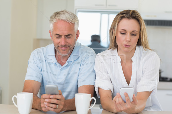 Distant couple sitting at the counter texting and not talking Stock photo © wavebreak_media