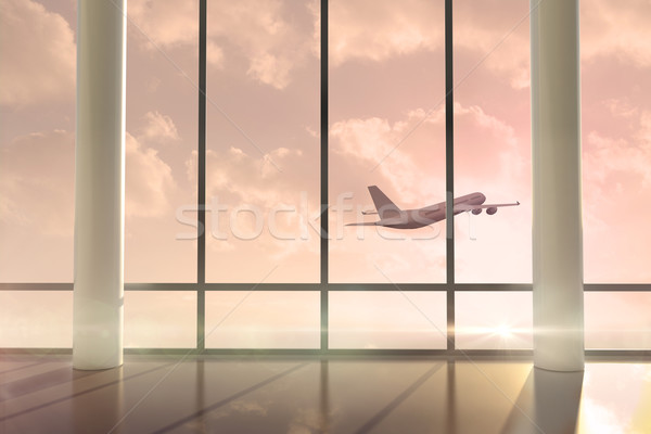 Airplane flying past window at sunrise Stock photo © wavebreak_media