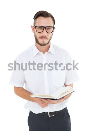 Stock photo: Geeky young man reading from black book