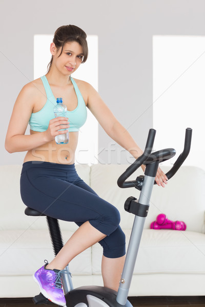 Stock photo: Fit brunette working out on exercise bike