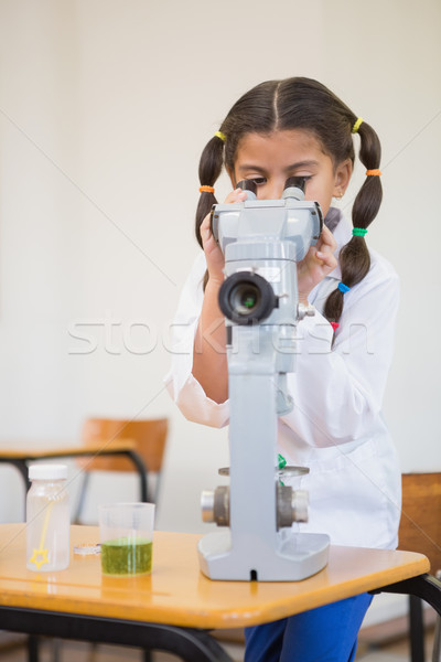 Stock photo: Cute pupil dressed up as scientist in classroom