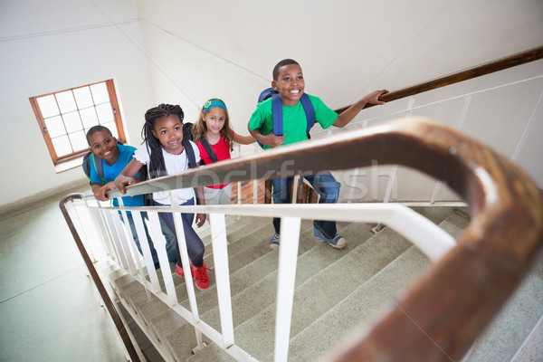 Cute uczniowie uśmiechnięty spaceru w górę schody Zdjęcia stock © wavebreak_media