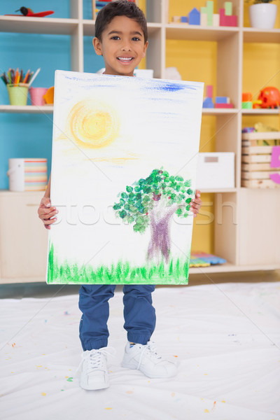 Stock photo: Cute little boy showing his painting in classroom