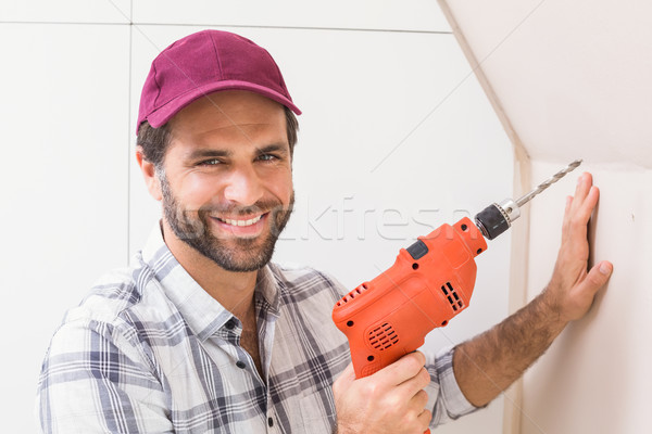 Construction worker drilling hole in wall Stock photo © wavebreak_media