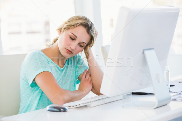 Portrait of a bored businesswoman leaning on her desk Stock photo © wavebreak_media
