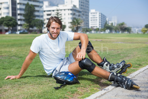 Fit man getting ready to roller blade Stock photo © wavebreak_media