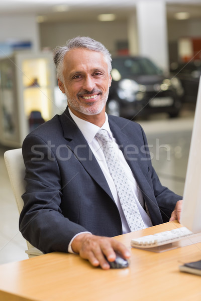 Cheerful businessman working at his desk Stock photo © wavebreak_media