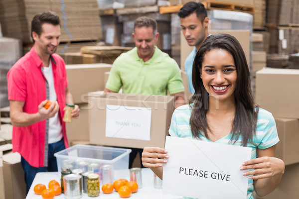 Stock photo: Warehouse workers packing up donation boxes