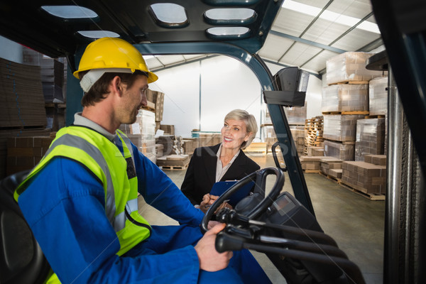 Warehouse manager talking with forklift driver Stock photo © wavebreak_media