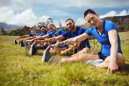 Close up of men playing rugby while lying at grassy field Stock photo © wavebreak_media
