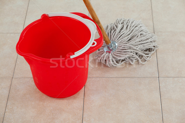 Stock photo: Empty bucket and mop on tile floor