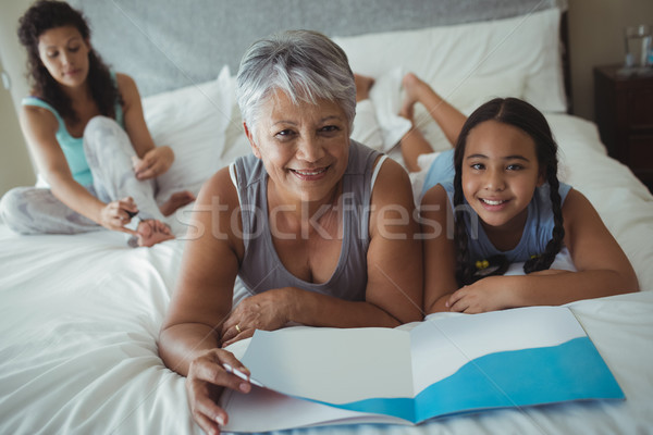 Happy family relaxing on bed in bed room Stock photo © wavebreak_media