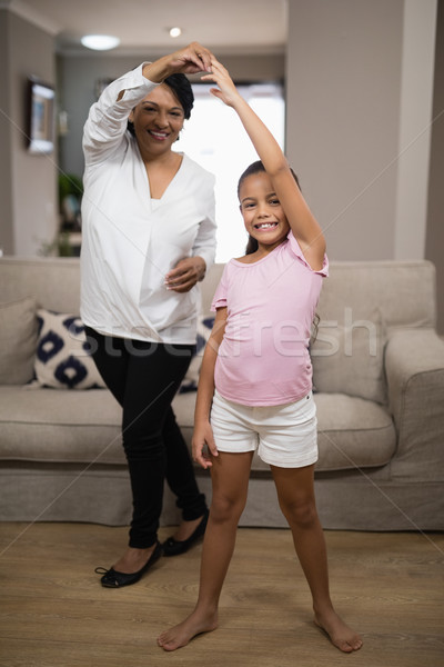 Portrait of smiling girl dancing with grandmother Stock photo © wavebreak_media