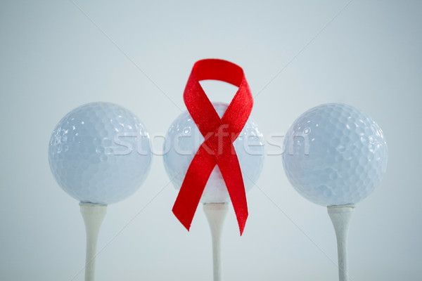 Close-up of red AIDS Awareness ribbon on golf ball Stock photo © wavebreak_media