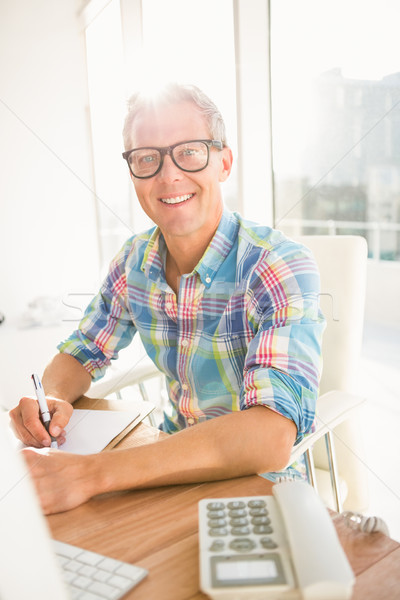 Smiling casual designer working at his desk Stock photo © wavebreak_media