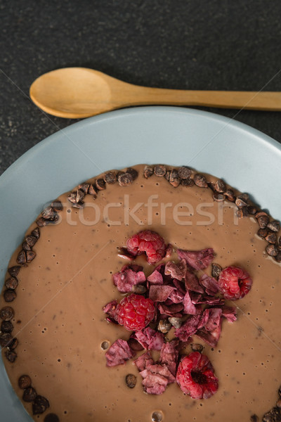 Chocolate syrup with fruits in bowl on black background Stock photo © wavebreak_media