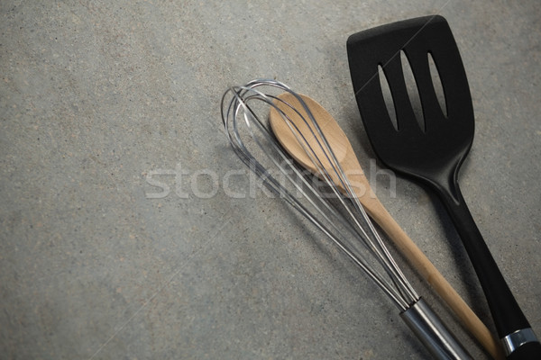 High angle view of wire whisk and wooden spoon by spatula Stock photo © wavebreak_media